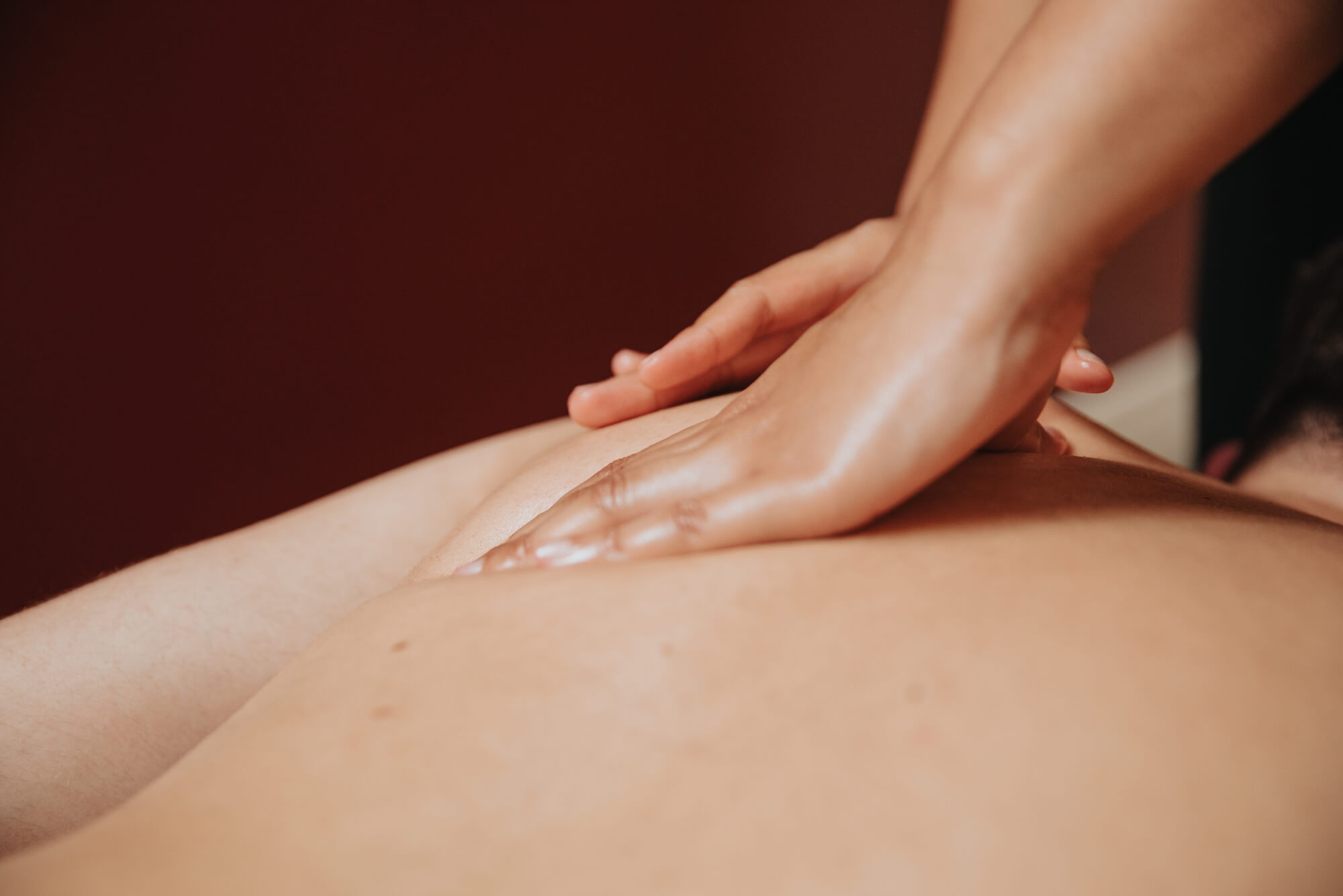 Closed up of a hand massaging the shoulder back