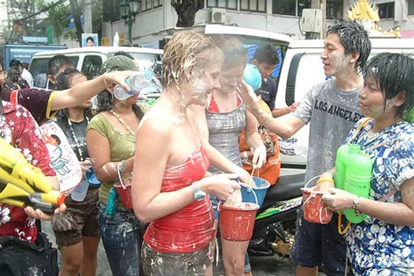 People in street celebrating Songkran Festival