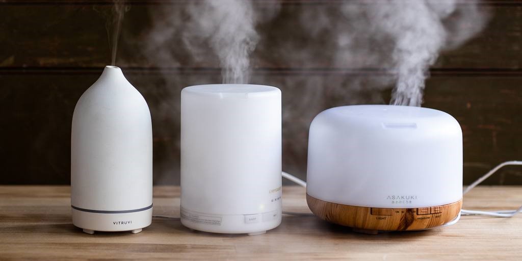 Aroma composition in different shape with a modern aroma oil diffuser on a wooden surface
