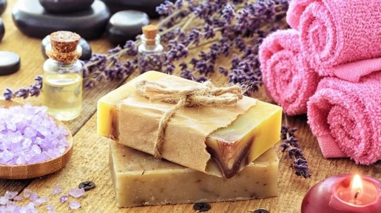 Lavender soap and salt on rustic wooden board. Spa concept