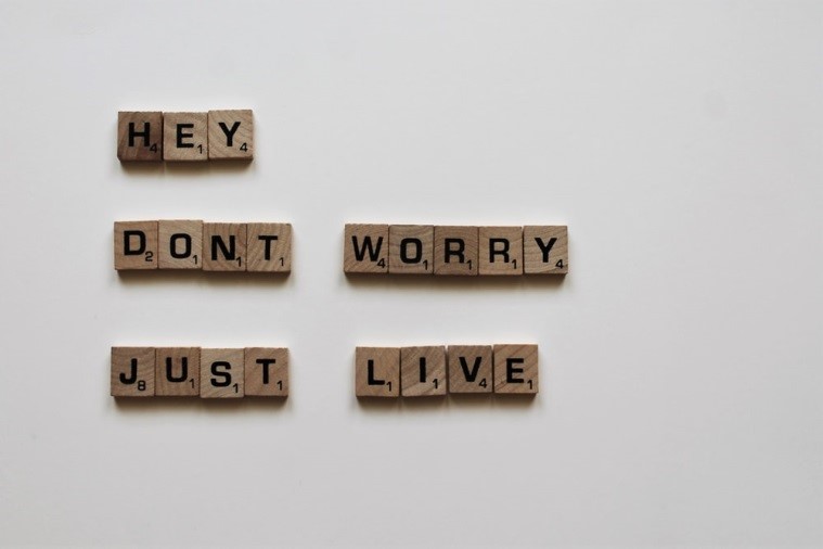 Wooden cubes with black letters laid out on a gray concrete background stock photo